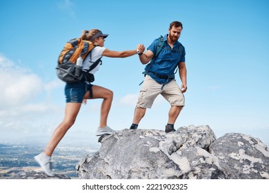 Helping Hand, Couple Climbing Or Hiking Mountain In Nature On Vacation, Holiday Or Trip. Freedom, Rescue Support And Traveling Man And Woman Outdoors In Countryside Rock Climbing, Exercise Or Workout