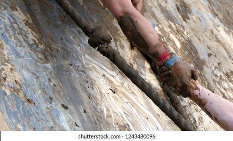 Helping Hand During A Obstacle Mud Run