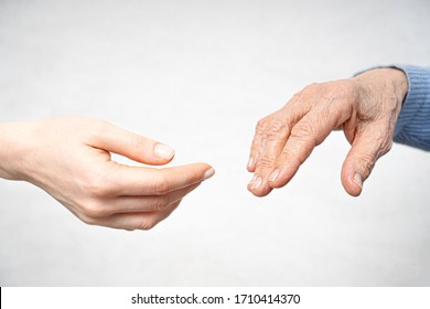 Helping hand for the elderly concept with young hand and old hand. 
