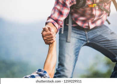 Helping hand outstretched for salvation . Strong hold. Couple hiking help each other in mountains . Two people climbing on mountain and helping. - Shutterstock ID 1259229511
