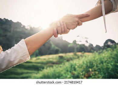 Helping hand outstretched for salvation . Strong hold. Couple hiking help each other in mountains . Two people climbing on mountain and helping. - Shutterstock ID 2174810417