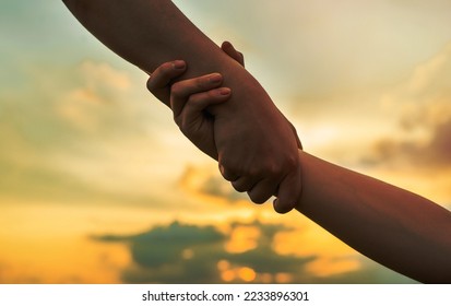 Helping hand outstretched for salvation . Strong hold.; - Shutterstock ID 2233896301