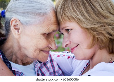 Helping Hands, Care For The Elderly Concept Closeup. Senior And Caregiver Holding Hands At Home