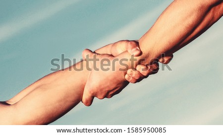 Helping hands concept, support. Close up help arm and international day of peace, support. Hands of on blue sky background.