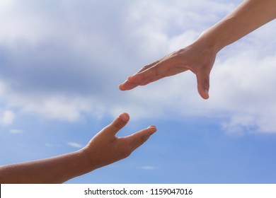 Helping hands, sky background, Rescue concept, religion.