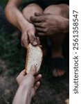 Helping the homeless poor. Moment of kindness: offering bread to a homeless person. Conveys compassion and humanity in adversity. Ideal for themes of charity and empathy