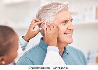 Helping, man and doctor with hearing aid, technology or healthcare or medical device consultation for deaf patient with tinnitus. Listening, test and exam ear tech with nurse or senior male in clinic - Powered by Shutterstock