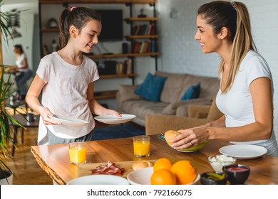 Helping Mother To Set Up A Table