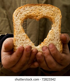 Helping The Needy Concept With Dirty Hands Of A Child Holding Slice Of Bread