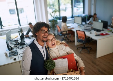 Helping your colleague move to a higher position in the firm, young businesspeople hugging eachother - Powered by Shutterstock