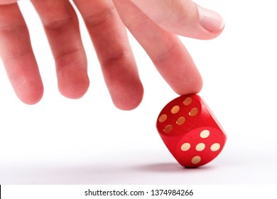 Helping Your Luck, Cheating In Games, Dishonesty Concept. A Human Finger Pushing Over A Dice To Make It Show A Six. Unfair Ace In The Sleeve, Cheater, Uneven Odds In Business Concept