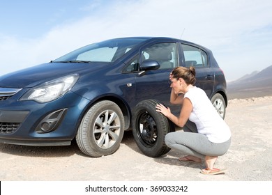 Helpless Woman Changing Tires