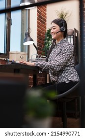 Helpline Support Operator Answering Customer Call Regarding Failed Transaction And Payment System Issue. Happy Asian Sales Agent With Headset On Call With Potential Product Buyer.