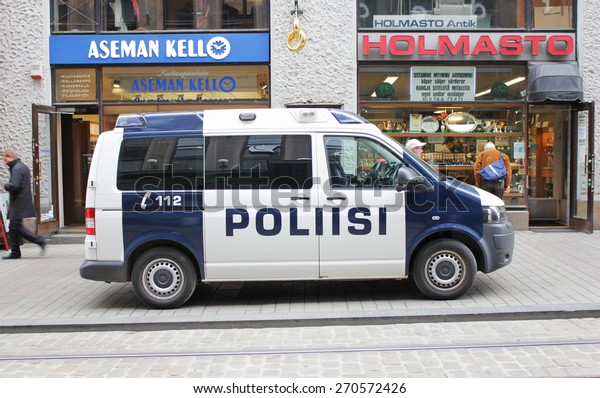 HELSINKI - APRIL 26, 2013: Side view of Finnish\
Police Van at Aleksanterinkatu street.  Aleksanterinkatu is a\
popular tourist attraction and shopping area in the center of city,\
April 26, 2013