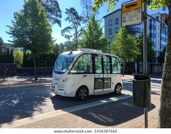 Helsinki, Finland -06-28-2019: Robot bus or\
driverless bus on its route in Southern Helsinki. Autonomous bus\
drives along its route like a lift. It scans its surroundings  and\
knows when to slow\
down.