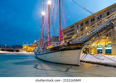 Helsinki, Finland: 2 22 2022 Wooden Sailing Ship Moored In Port During A Frosty Winter Night. Historic Boat Among The Frozen Water Covered With Floe In The Beautiful Lights Of The Night.