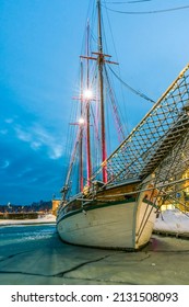 Helsinki, Finland: 2 22 2022 Wooden Sailing Ship Moored In Port During A Frosty Winter Night. Historic Boat Among The Frozen Water Covered With Floe In The Beautiful Lights Of The Night.