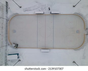HELSINKI, FINLAND - JANUARY 31, 2022: Drone View From Above Of Zamboni Clearing The Ice In Käpyä Outdoor Ice Hockey Rink.