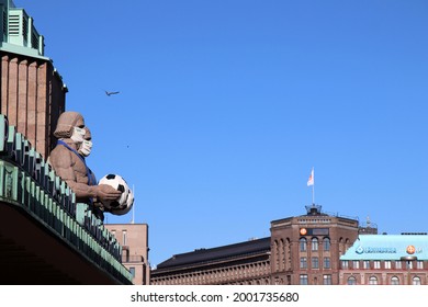 Helsinki, Finland - July 03 2021: The Statues Of The Main Railway Station Of Helsinki Are Wearing Masks And Holding A Football To Honor The EM Football Championship.