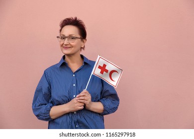 Helsinki, Finland - June 07 2018: IFRC International Federation Of Red Cross And Red Crescent Societies Flag. Woman Holding Red Cross Flag. Editorial Use Only.