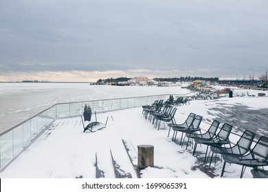 Helsinki / Finland - March, 8th, 2017.
Canned Idle Restaurant Terrace With Iew Of The Frozen Sea, Everything Is Covered With Snow. Depression, Hibernation, Business Closure.