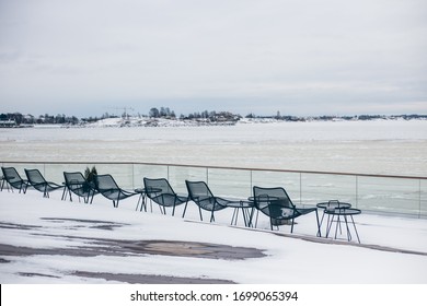 Helsinki / Finland - March, 8th, 2017.
Canned Idle Restaurant Terrace With Iew Of The Frozen Sea, Everything Is Covered With Snow. Depression, Hibernation, Business Closure.