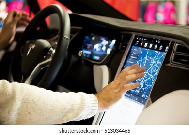 HELSINKI, FINLAND - NOVEMBER 04, 2016: The Interior Of A Tesla Model X Electric Car With Large Touch Screen Dashboard.  Hand Using Gps Navigation System. 