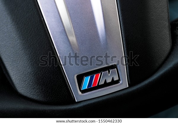 Helsinki, Finland, November 4, 2019:\
Close up view of a BMW M Logo on black leather steering wheel\
sports car. M Performance Edition. Car exterior\
details.