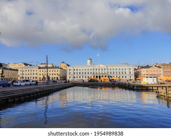 Helsinki Finland October 30 2020. View Of The Harbor In Helsinki City. Old Buildings On The Waterfront In Town. Market Place On A Square In Front White Building With Finnish Flag Outside.