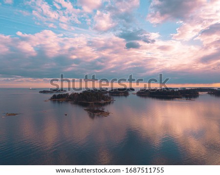 Helsinki islands. Scandinavian sea landscape.
Beautiful sunset with reflection of clouds in the sea
Aerial top down drone shot.