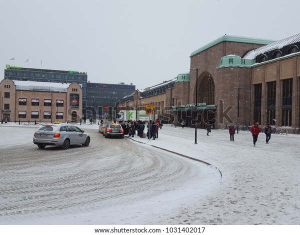 Helsinki,Finland - Feb 23: People queue for taxi in\
front of Train station with - 10 degree winter in Helsinki,Finland\
Feb 23, 2018 