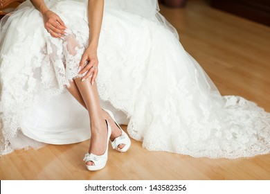 Hem Of Her Dress. Bride Shoes. Lace Train Wedding Dress.