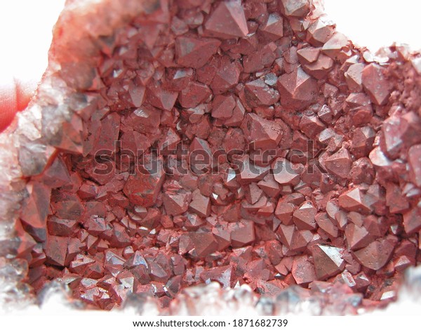  Hematite coated red\
quartz crystals attached to the inside of the vug, front on view\
and close up.