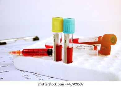 Hematology Blood Analysis Report With Blood Sample Collection Tubes And Syringe. (blue Tone)