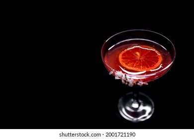 hemingway daiquiri cocktail drink with grapefruit in glass on black background