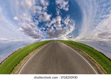 Hemisphere Of The Planet On An Asphalt Road Stretching Beyond The Horizon With Blue Sky And Beautiful Clouds. Spherical Abstract Aerial View. Curvature Of Space.