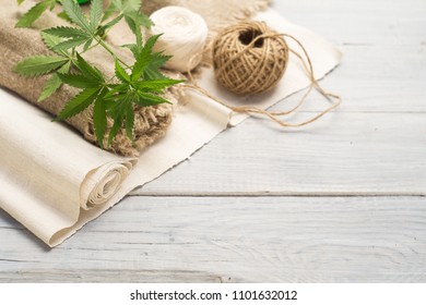 Hemp canvas and threads on a white wooden surface