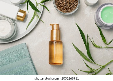 Hemp Cosmetics And Green Leaves On Light Table, Flat Lay