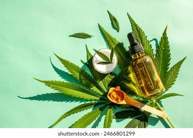 Hemp leaf for cosmetic purposes. Marijuana oil, capsules on a menthol background. Medicine, legalization. View from above