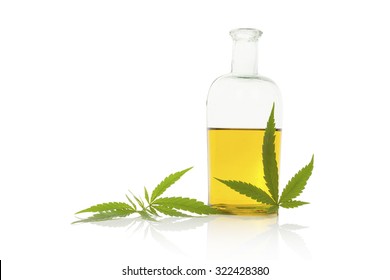 Hemp oil and cannabis leaf isolated on white background. Healthy cannabis oil. 