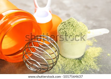 Hemp protein powder in measuring scoop on table