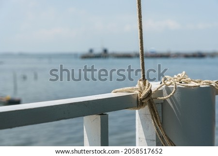 Hemp rope tied to the railings at the beach.