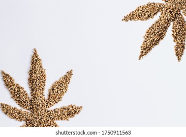 Hemp seeds on white background. Hemp Seeds in the Form of Cannabis Leaf. Top view. Flat lay