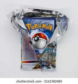 Hempstead, NY USA - May 27, 2022: Opening A Fresh Pack Of Pokémon Cards Against A White Background