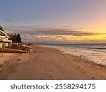 Henley Beach, South Australia, features golden sands and calm waters, offering stunning westerly views of sunsets. This peaceful beach is a perfect spot to relax.