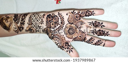 henna drawing on hands in india, 
Mehndi (Henna is a paste often associated with good fortune and positivity. It is one of the oldest forms of body art. Women and girls get their hands and feet.