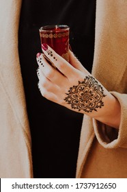 Henna Mandala On Hand Holding Red Moroccan Tea Glass