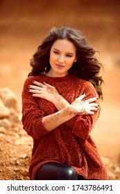 Henna Mehndi. Mehendi On Hands. Outdoor Portrait Of Attractive Woman In Sweater With Curly Hair.