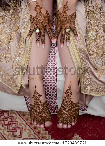 Henna On Womans Legs. Mehndi, application of henna as skin decoration.
