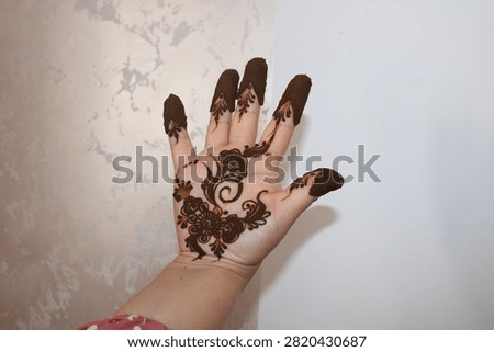 a henna pattern on a woman's hand